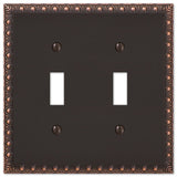 Amerelle Egg & Dart Double Toggle Cast Metal Wallplate in Aged Bronze
