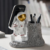 BUTILIVEEN Astronaut Pen Pencil Holder with Phone Stand, Resin Spaceman Pen Container Cell Phone Stand for home Office Desktop D