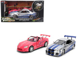 Brians Nissan Skyline GTR (R34) Silver Metallic with Blue Stripes and Sukis Honda S2000 Pink with Graphics Set of 2 Cars Fas