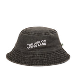 'YOU ARE ON NATIVE LAND' BUCKET HAT